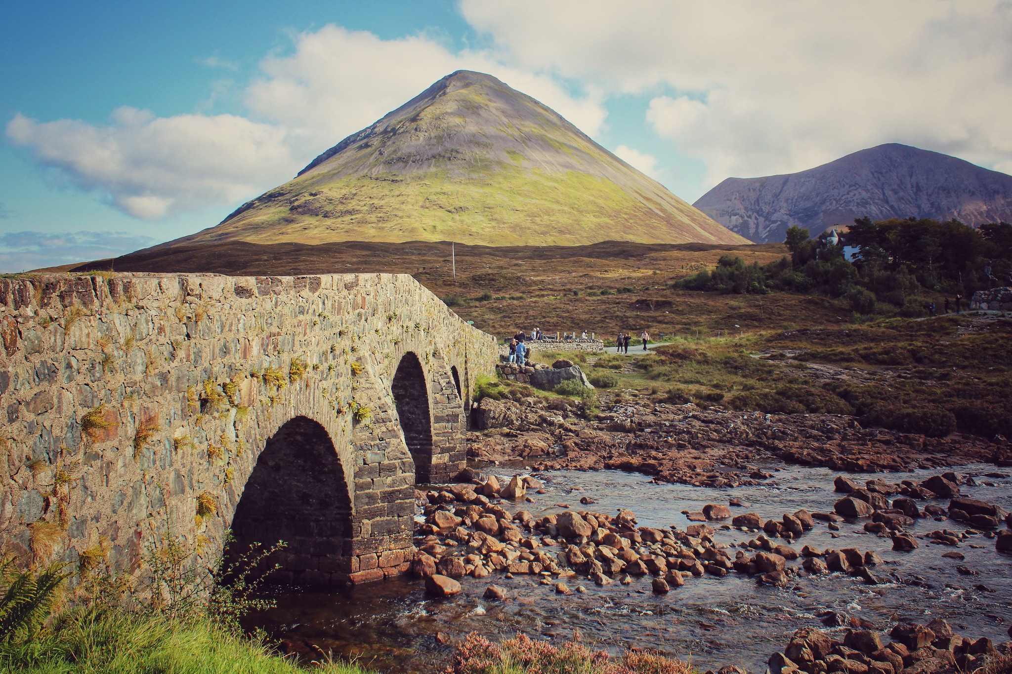 The old stone bridge at Sligachan crossing a rocky stream beneath the mountains of Skye